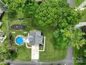 Aerial view of a private backyard featuring a swimming pool and landscaped yard at 240 Hillcrest Dr, Harrisburg, NC 28075