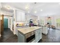 Open kitchen featuring custom island, bar seating, stainless appliances, and ample counter space at 266 Riverwood Rd, Mooresville, NC 28117