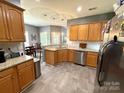 Open kitchen with granite countertops, stainless steel appliances, and wooden cabinetry at 3110 Richards Way Dr, Rock Hill, SC 29732