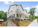 New townhome exterior with a retaining wall, showcasing the architectural design and community aesthetics at 3932 Hager Dr, Charlotte, NC 28208