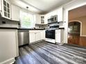 Well-equipped kitchen showcasing stainless steel appliances, ample counter space, and stylish backsplash at 423 N Cedar St, Lincolnton, NC 28092