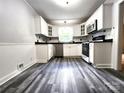 Bright kitchen featuring white cabinetry, modern appliances, and a sleek countertop at 423 N Cedar St, Lincolnton, NC 28092