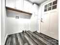 Functional laundry room with storage cabinets, modern flooring, and convenient access to the exterior at 423 N Cedar St, Lincolnton, NC 28092