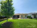 Beautiful backyard with a well-kept lawn and stone patio and fire pit at 5003 Looking Glass Trl, Denver, NC 28037