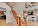 Beautiful staircase with wood treads, iron spindles, and view into the light-filled living room at 508 Whitehead Ct # 328, Fort Mill, SC 29708