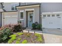 A charming two-story townhome with a lovely blue door and attached one car garage at 5324 Somerset Hill Ln, Charlotte, NC 28269