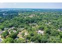 Expansive aerial view of the neighborhood with mature trees and beautiful homes and nearby lake at 541 Greenway St, Davidson, NC 28036