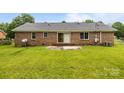 Spacious backyard with a brick exterior and concrete patio for outdoor enjoyment at 5918 Barrington Dr, Charlotte, NC 28215