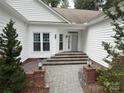 Close up of home entrance highlighting the stone steps and tidy landscaping at 5929 Waterelm Ln, Charlotte, NC 28269
