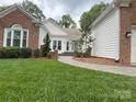 Charming walkway leading to the front door, complimented by lush green lawn and mature landscaping at 5929 Waterelm Ln, Charlotte, NC 28269