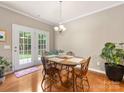 Bright dining area with hardwood floors, French doors, and a chandelier at 6619 Hermsley Rd, Charlotte, NC 28278