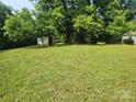 Large backyard featuring a grassy area and a small outbuilding at 76 Sumner Nw Ave, Concord, NC 28027