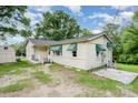Cozy home with green awnings, a small front porch, and a storage shed at 8334 Oaktree Rd, Sharon, SC 29742