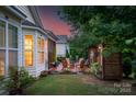 Relaxing backyard oasis with a brick patio, fire pit area, and lush landscaping at 8725 Soaring Eagle Ln, Waxhaw, NC 28173