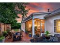 Inviting outdoor patio with brick flooring, comfortable seating, and a screened-in porch at 8725 Soaring Eagle Ln, Waxhaw, NC 28173