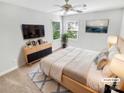 Comfortable bedroom with neutral walls, large windows, and stylish furnishings at 8803 Sweetwater Pl, Waxhaw, NC 28173