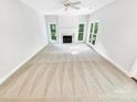Spacious living room with neutral carpet and large windows offering ample natural light at 8803 Sweetwater Pl, Waxhaw, NC 28173