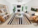 Bright, staged living room with fireplace, neutral decor, and ample natural light at 8803 Sweetwater Pl, Waxhaw, NC 28173