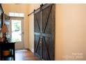 Entryway featuring sliding barn doors, wood flooring and access to natural light at 9805 Coatbridge Dr, Charlotte, NC 28269