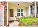 Cozy front porch with outdoor seating and well-kept landscaping for a welcoming entrance at 1003 Silver Spring Rd, Fort Mill, SC 29715