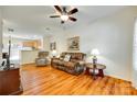Open living room with hardwood floors, neutral walls, and a glimpse into the adjacent kitchen at 1003 Silver Spring Rd, Fort Mill, SC 29715