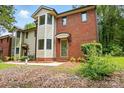 Inviting townhome with brick and siding, showcasing a well-manicured lawn at 1035 Wexford Nw Pl, Concord, NC 28027