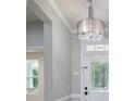 Bright foyer with decorative chandelier and ornate front door at 1211 Gold Rush Ct, Fort Mill, SC 29708