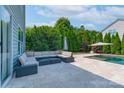 A view of the travertine patio with furniture and landscaping at 1211 Gold Rush Ct, Fort Mill, SC 29708