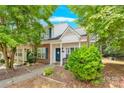 Charming townhouse with brick accents, manicured landscaping, and a welcoming front porch at 125 Lynch Cir, Mooresville, NC 28117