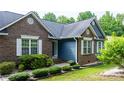 Charming home exterior with brick and siding, complemented by neat landscaping, window shutters and an inviting entryway at 1305 Creekview Dr, Gastonia, NC 28052