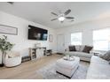 A comfortable living room with ample seating, a decorative media center, and lots of natural light at 13422 Calloway Glen Dr, Charlotte, NC 28273