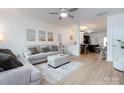 Bright and airy living room featuring modern decor and an open floor plan leading to the kitchen at 13422 Calloway Glen Dr, Charlotte, NC 28273