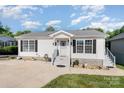Inviting one-story home boasting well-maintained landscaping and a neatly paved driveway at 161 Badin Lake Cir, New London, NC 28127