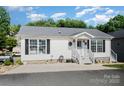 Attractive one-story home with a welcoming entrance and black window shutters at 161 Badin Lake Cir, New London, NC 28127