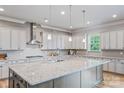 The gourmet kitchen offers granite countertops, stainless steel appliances, and a large center island perfect for entertaining at 1702 Batson Creek Ln, Weddington, NC 28104