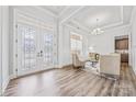 Living room boasts natural light, recessed lights, and a decorative glass-paneled door and windows at 1702 Batson Creek Ln, Weddington, NC 28104