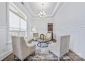 Sitting area showcases a decorative ceiling, wainscoting, neutral colors, and a modern chandelier at 1702 Batson Creek Ln, Weddington, NC 28104