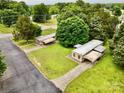 Aerial view of charming homes nestled among mature trees, showcasing well-maintained lawns and serene surroundings at 1733 S Nc 16 Business Hwy, Stanley, NC 28164