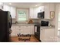 Bright staged kitchen with stainless steel appliances and granite countertops at 2015 Downey St, Rock Hill, SC 29732