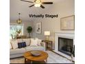 Bright staged living room with hardwood floors, vaulted ceiling, fireplace and sliding glass doors at 2015 Downey St, Rock Hill, SC 29732