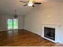 Bright living room with hardwood floors, vaulted ceiling, fireplace and sliding glass doors to the backyard at 2015 Downey St, Rock Hill, SC 29732