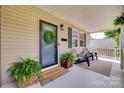 Inviting covered front porch with comfortable seating and decorative plants at 203 Lincoln St, Belmont, NC 28012