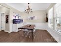 The dining room features wood flooring, a chandelier, and a large saltwater aquarium at 2210 Winding River Dr, Charlotte, NC 28214