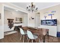 The dining room features a unique light fixture, wood flooring, and an eye-catching aquarium at 2210 Winding River Dr, Charlotte, NC 28214