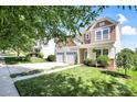 Traditional two-story home with a two-car garage and manicured lawn with lush green foliage at 2210 Winding River Dr, Charlotte, NC 28214