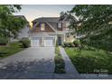 Charming two-story home with a well-manicured lawn, inviting entrance, and a spacious two-car garage at 2210 Winding River Dr, Charlotte, NC 28214
