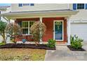 Inviting front porch with brick facade, cozy seating, and neat landscaping, offering a welcoming entrance at 2234 Dion Ave, Charlotte, NC 28212
