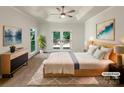 Tranquil main bedroom showcasing tray ceiling, french doors to deck and contemporary furniture at 2312 Christensens Ct, Charlotte, NC 28270