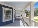 View of a relaxing front porch with a hanging swing and natural light at 2315 Winthrop Ave, Charlotte, NC 28203