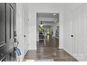 Bright foyer with hardwood floors and a view into the open-concept dining and living spaces at 3127 Pinehills Way, Mount Holly, NC 28120